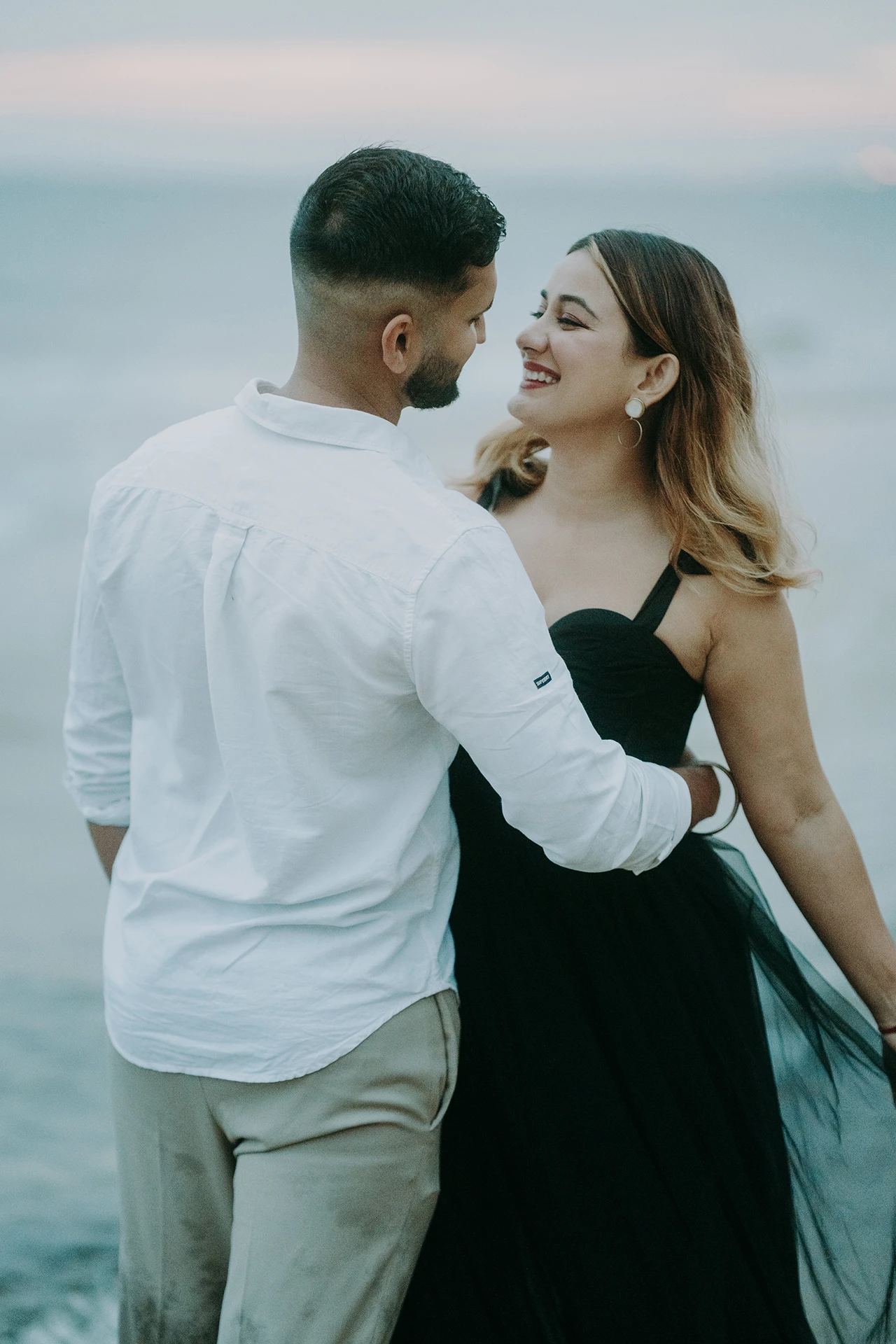 Elegant pre-wedding portrait of an South Asian couple at a beach